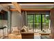 Cozy living room with wood beams, comfortable seating, and sliding glass doors to a deck at 7116 Grandview Rd, Columbus, IN 47201