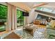 Sun-drenched living room featuring wood floors, skylight, and deck access at 7116 Grandview Rd, Columbus, IN 47201
