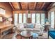 Bright living room with log walls, large windows and comfortable seating at 7116 Grandview Rd, Columbus, IN 47201