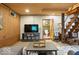 Finished basement living room with carpet, television and access to a bathroom and wooden staircase at 7116 Grandview Rd, Columbus, IN 47201