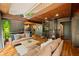 Open-concept living room featuring wood accents, fireplace, spiral staircase, and comfortable furniture at 7116 Grandview Rd, Columbus, IN 47201