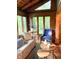 Cozy living area featuring log walls, natural light, and comfortable furnishings at 7116 Grandview Rd, Columbus, IN 47201
