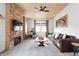 Inviting living room featuring a stone fireplace, modern furniture, and wood accents at 7116 Grandview Rd, Columbus, IN 47201