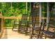 Relaxing porch features rocking chairs with natural wood decking, creating a peaceful outdoor space at 7116 Grandview Rd, Columbus, IN 47201