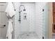 Modern bathroom shower featuring white subway tile and matte black hardware at 7116 Grandview Rd, Columbus, IN 47201
