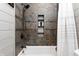 Modern tiled shower with a built-in niche with decorative pebble accents at 7116 Grandview Rd, Columbus, IN 47201