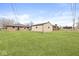 The backyard shows the detached garage with a lush green lawn at 714 S 4Th Ave, Beech Grove, IN 46107