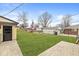 Spacious backyard featuring a well-kept lawn and detached garage at 714 S 4Th Ave, Beech Grove, IN 46107