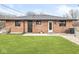 Backyard view of the home's brick exterior and a well-maintained lawn at 714 S 4Th Ave, Beech Grove, IN 46107