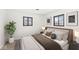 Cozy bedroom features a neutral palette, two windows, and a lush potted plant at 714 S 4Th Ave, Beech Grove, IN 46107