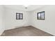 This bedroom features neutral carpet, two windows, white walls, and baseboard heaters at 714 S 4Th Ave, Beech Grove, IN 46107