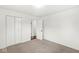 This bedroom features neutral carpet, a closet with folding doors, and access to another room at 714 S 4Th Ave, Beech Grove, IN 46107