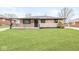 Charming brick home featuring a covered porch and manicured front lawn at 714 S 4Th Ave, Beech Grove, IN 46107