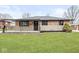 Charming brick home featuring a covered porch and manicured front lawn at 714 S 4Th Ave, Beech Grove, IN 46107