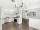 The kitchen features stainless steel appliances, crisp white cabinetry, and hardwood floors at 714 S 4Th Ave, Beech Grove, IN 46107