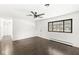 Spacious living room featuring wood-look flooring, a large window, and natural light at 714 S 4Th Ave, Beech Grove, IN 46107