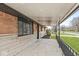 Inviting covered porch with brick accents and wrought iron railing at 714 S 4Th Ave, Beech Grove, IN 46107