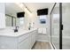 Elegant bathroom with dual vanities, modern fixtures, and a sleek glass shower, showcasing style and functionality at 7346 Shroyer Way, Noblesville, IN 46062
