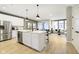 Modern kitchen with white cabinets, stainless steel appliances, and an island open to the living area at 7346 Shroyer Way, Noblesville, IN 46062