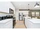 Contemporary kitchen featuring stainless steel appliances, white cabinets, and a center island with seating at 7346 Shroyer Way, Noblesville, IN 46062