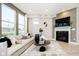 Cozy living room featuring a modern fireplace, large windows and comfortable seating at 7346 Shroyer Way, Noblesville, IN 46062