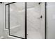 Luxurious walk-in shower with sleek glass enclosure, rainfall showerhead, built-in bench, and modern tile design at 7346 Shroyer Way, Noblesville, IN 46062