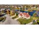Beautiful aerial view of brick home with a red tile roof, a lush lawn and waterfront access at 7370 Chestnut Hills Blvd, Indianapolis, IN 46278