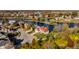 Aerial view of a lakefront neighborhood with homes and vibrant fall foliage at 7370 Chestnut Hills Blvd, Indianapolis, IN 46278