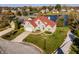 Aerial view of a lovely home with red roof overlooking the water in a quiet residential neighborhood at 7370 Chestnut Hills Blvd, Indianapolis, IN 46278