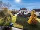 Expansive backyard featuring a deck, lush green lawn, and lake access with a serene view at 7370 Chestnut Hills Blvd, Indianapolis, IN 46278