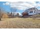 Large backyard featuring a well-maintained lawn and a wooden deck, perfect for outdoor gatherings at 7370 Chestnut Hills Blvd, Indianapolis, IN 46278