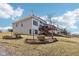Back of house view with brick siding, wooden decks, and professional landscaping, creating a relaxing outdoor space at 7370 Chestnut Hills Blvd, Indianapolis, IN 46278