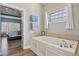 Bathroom featuring soaking tub and a window, adjacent to the main bedroom at 7370 Chestnut Hills Blvd, Indianapolis, IN 46278