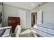 Bedroom features a bed with striped comforter, desk, and dresser at 7370 Chestnut Hills Blvd, Indianapolis, IN 46278