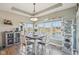 Cozy dining room with large windows offering scenic water views, complemented by stylish decor and a modern light fixture at 7370 Chestnut Hills Blvd, Indianapolis, IN 46278