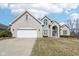 Charming two-story home features a brick facade, attached two car garage, and manicured lawn at 7370 Chestnut Hills Blvd, Indianapolis, IN 46278