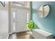 Bright foyer features a large arched window above the front door and a round mirror accenting the teal wall at 7370 Chestnut Hills Blvd, Indianapolis, IN 46278