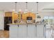 Kitchen island with white cabinets, granite countertop, pendant lights, and stainless steel appliances at 7370 Chestnut Hills Blvd, Indianapolis, IN 46278