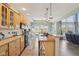 Modern kitchen open to the living room, featuring wood cabinets, granite countertops, and stainless steel appliances at 7370 Chestnut Hills Blvd, Indianapolis, IN 46278