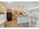 Open kitchen featuring wood cabinets, granite countertops, a kitchen island, and a breakfast nook at 7370 Chestnut Hills Blvd, Indianapolis, IN 46278