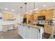 Well-lit kitchen with wood cabinets, granite countertops, a large island, and pendant lighting at 7370 Chestnut Hills Blvd, Indianapolis, IN 46278