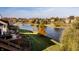 Beautiful lake view with surrounding trees in warm autumn colors behind a well maintained lawn at 7370 Chestnut Hills Blvd, Indianapolis, IN 46278