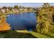 Scenic aerial view of a lakefront property with lush lawns and autumn foliage reflecting on the water at 7370 Chestnut Hills Blvd, Indianapolis, IN 46278