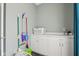 Functional laundry room with storage cabinets and cleaning supplies for efficient household chores at 7370 Chestnut Hills Blvd, Indianapolis, IN 46278