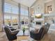 Bright living room with a fireplace, large windows, and comfortable seating, perfect for relaxing at 7370 Chestnut Hills Blvd, Indianapolis, IN 46278