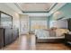 Bright main bedroom with hardwood floors, tray ceiling, a sitting area, and a large window at 7370 Chestnut Hills Blvd, Indianapolis, IN 46278