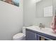 Powder room featuring a single sink vanity, brushed nickel faucet, and blue accent wall at 7370 Chestnut Hills Blvd, Indianapolis, IN 46278