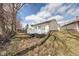 View of a house with a backyard featuring a wooden deck and a well-maintained lawn at 7621 Orchard Village Dr, Indianapolis, IN 46217