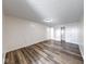 Bright bedroom featuring gray wood-look floors and a closet at 7621 Orchard Village Dr, Indianapolis, IN 46217
