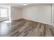 Spacious bedroom with gray wood-look flooring and a window at 7621 Orchard Village Dr, Indianapolis, IN 46217